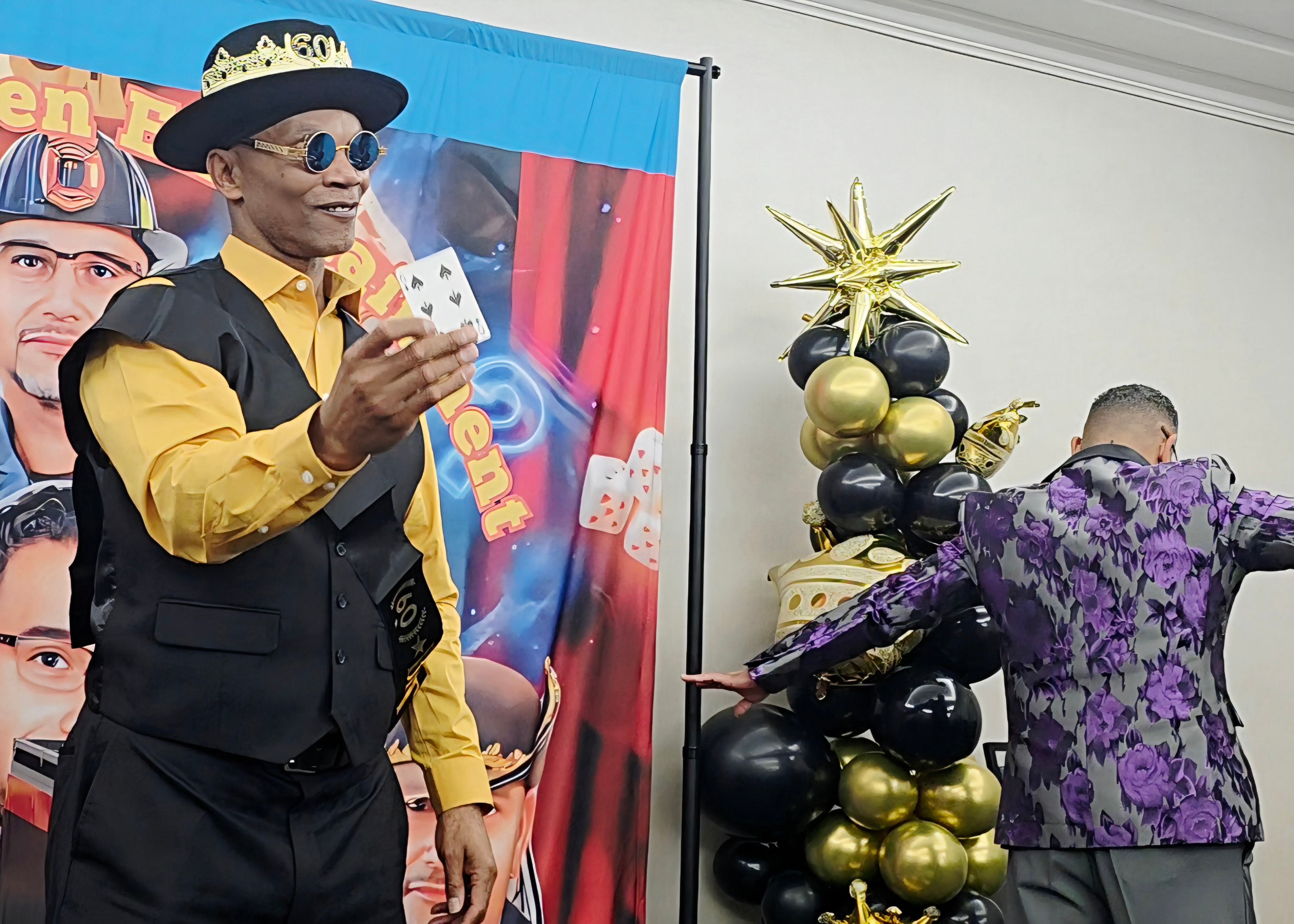 C. Magic in gold suit with playing cards