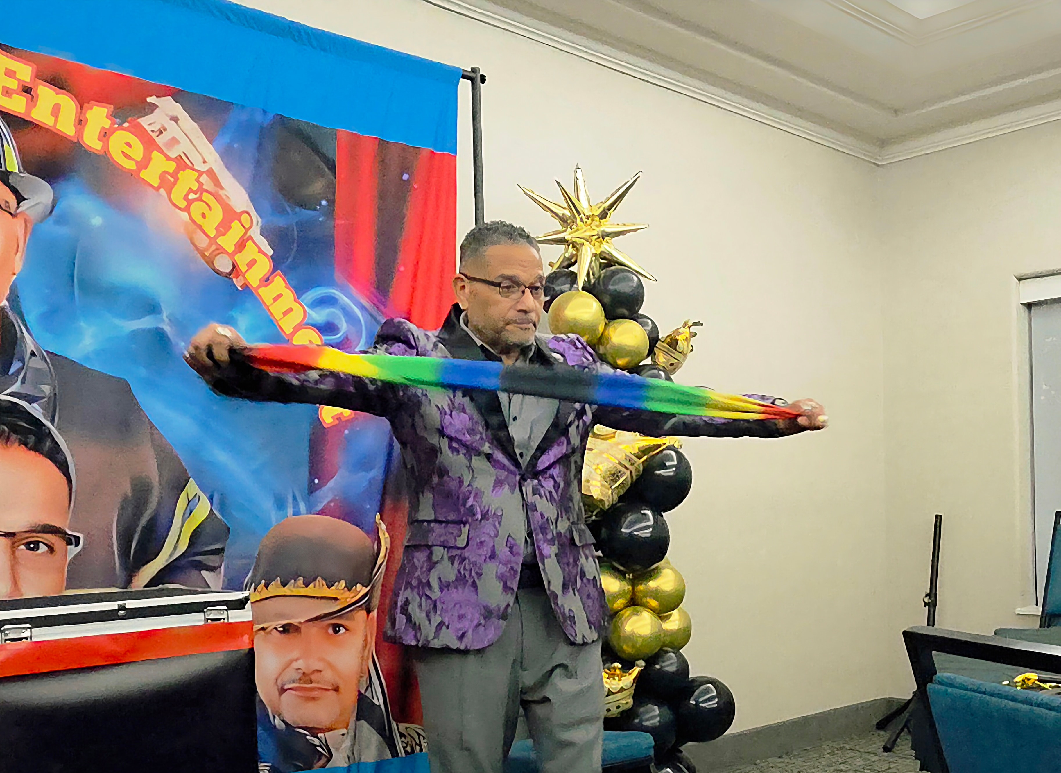 C. Magic holding rainbow staff on stage