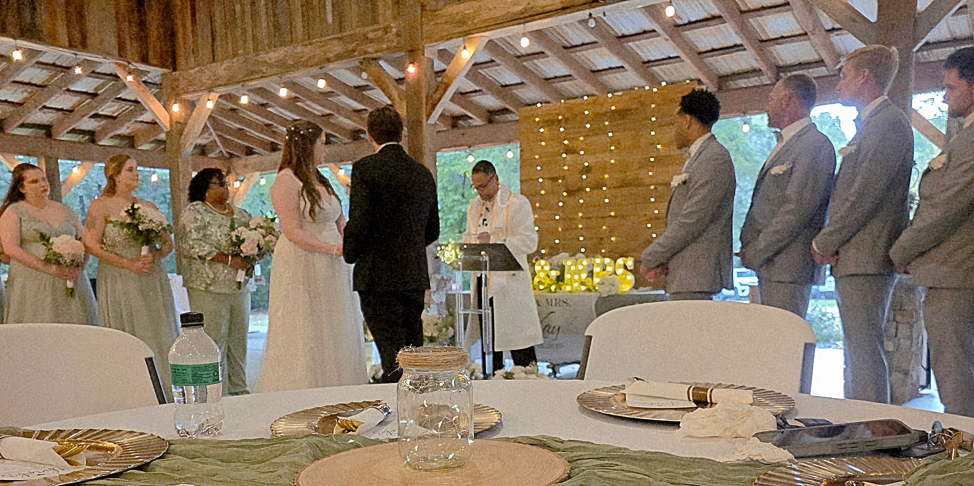 C. Magic officiating wedding ceremony in rustic barn venue