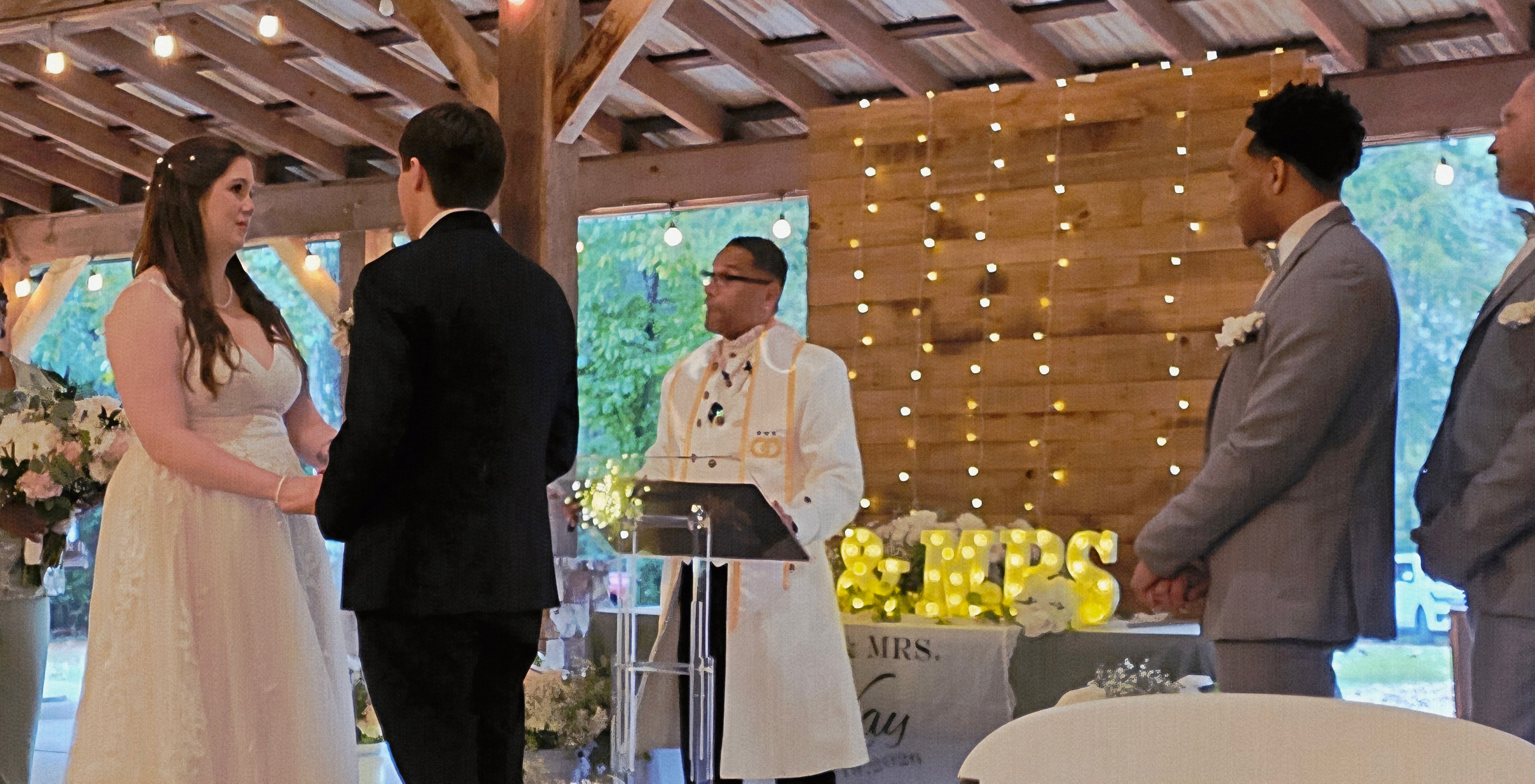 C. Magic officiating as bride and groom exchange vows at the altar