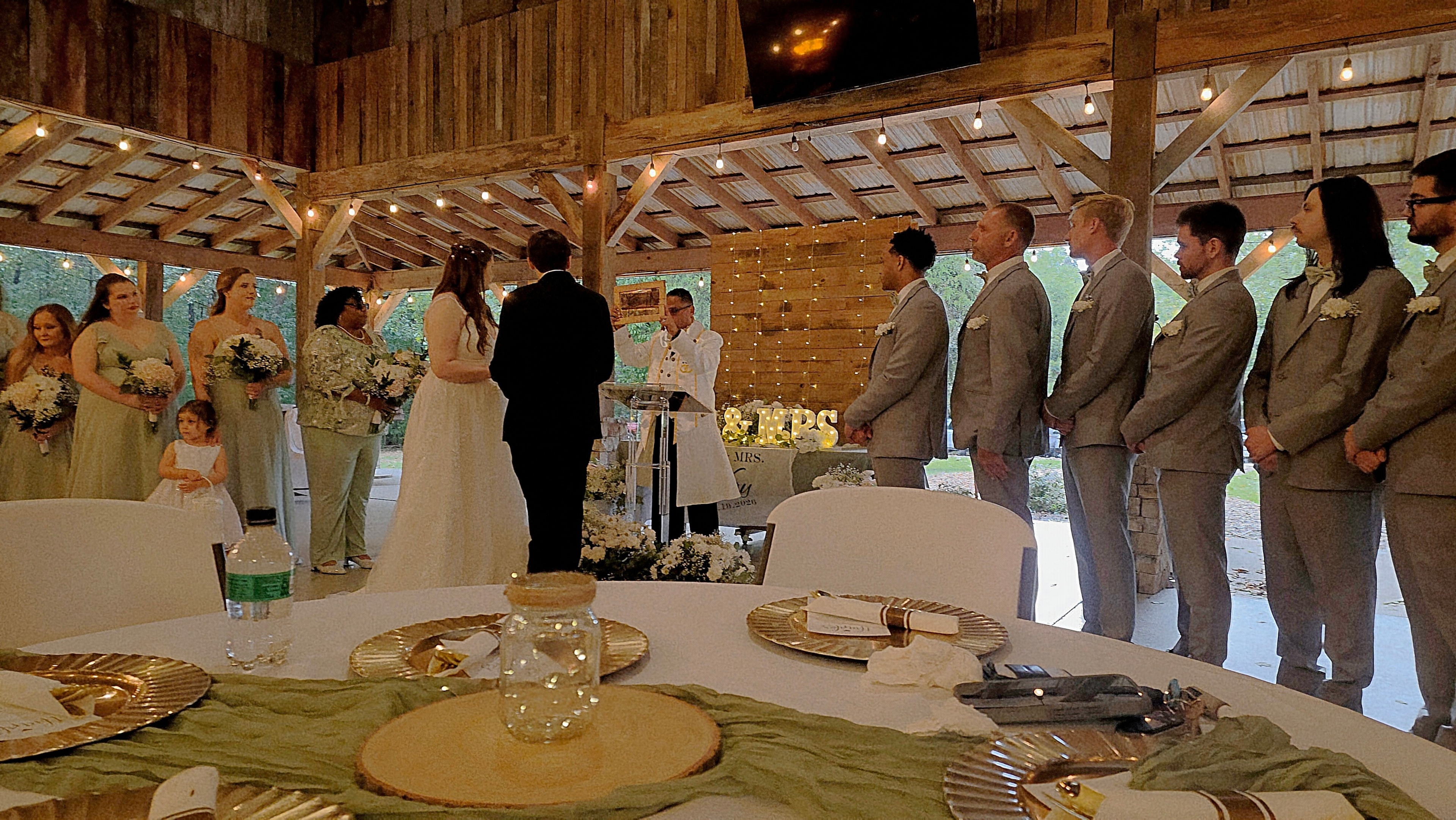 C. Magic performing magic during wedding ceremony with full bridal party