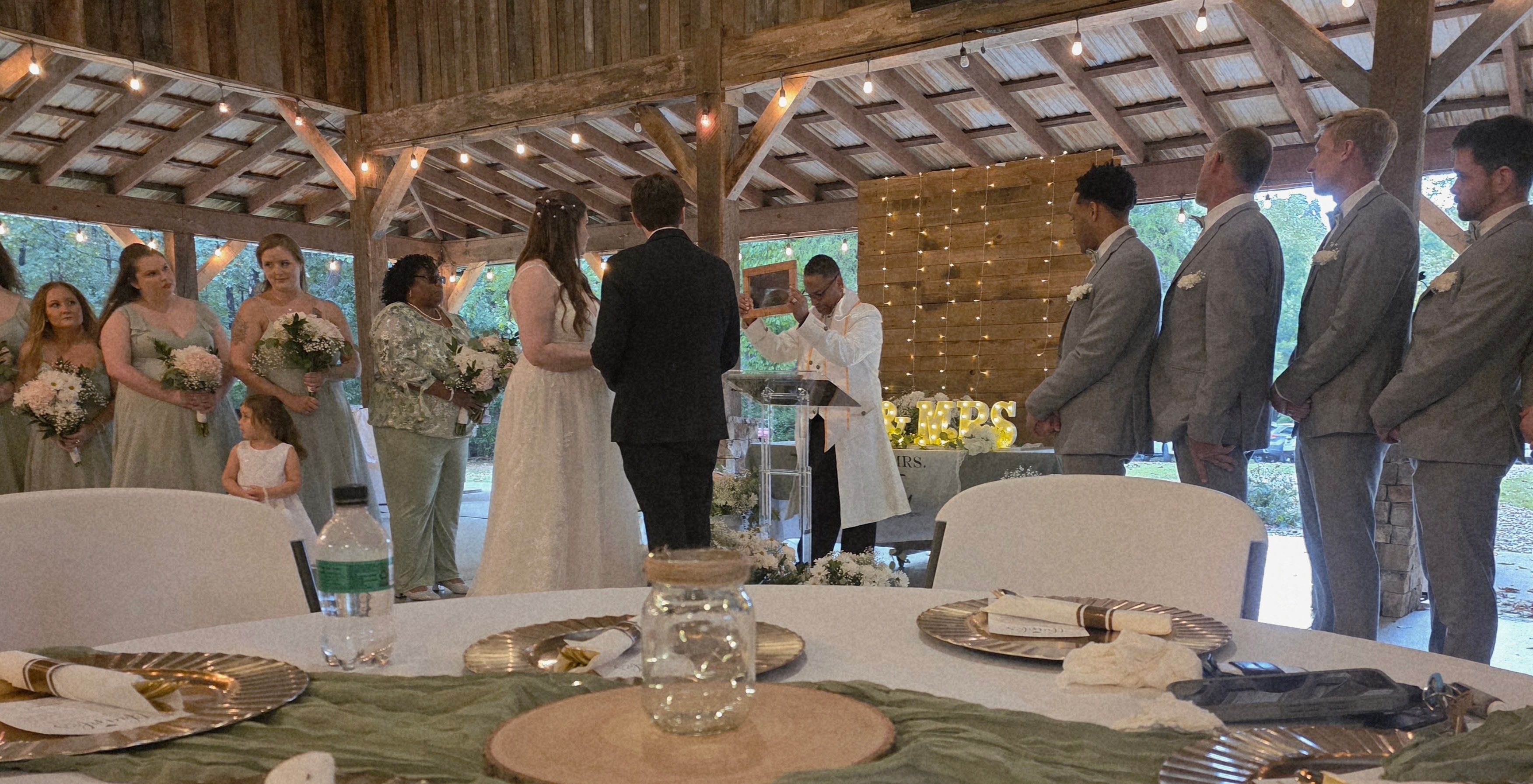 C. Magic officiating wedding ceremony with bridal party and groomsmen