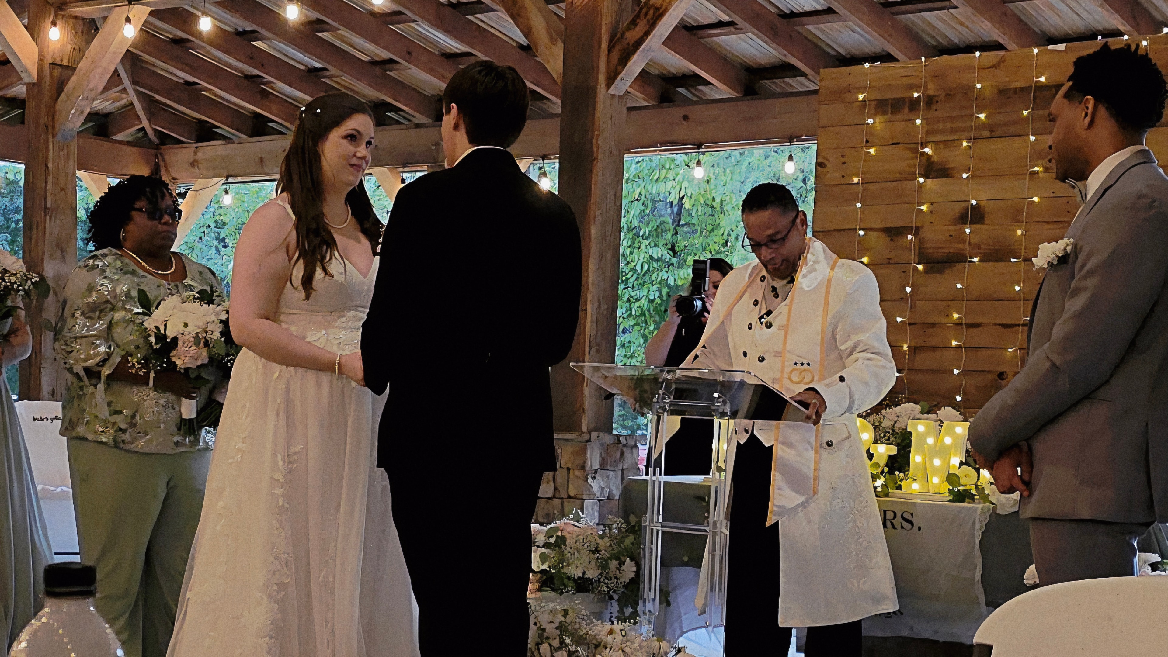 C. Magic officiating wedding ceremony with bride and groom exchanging vows