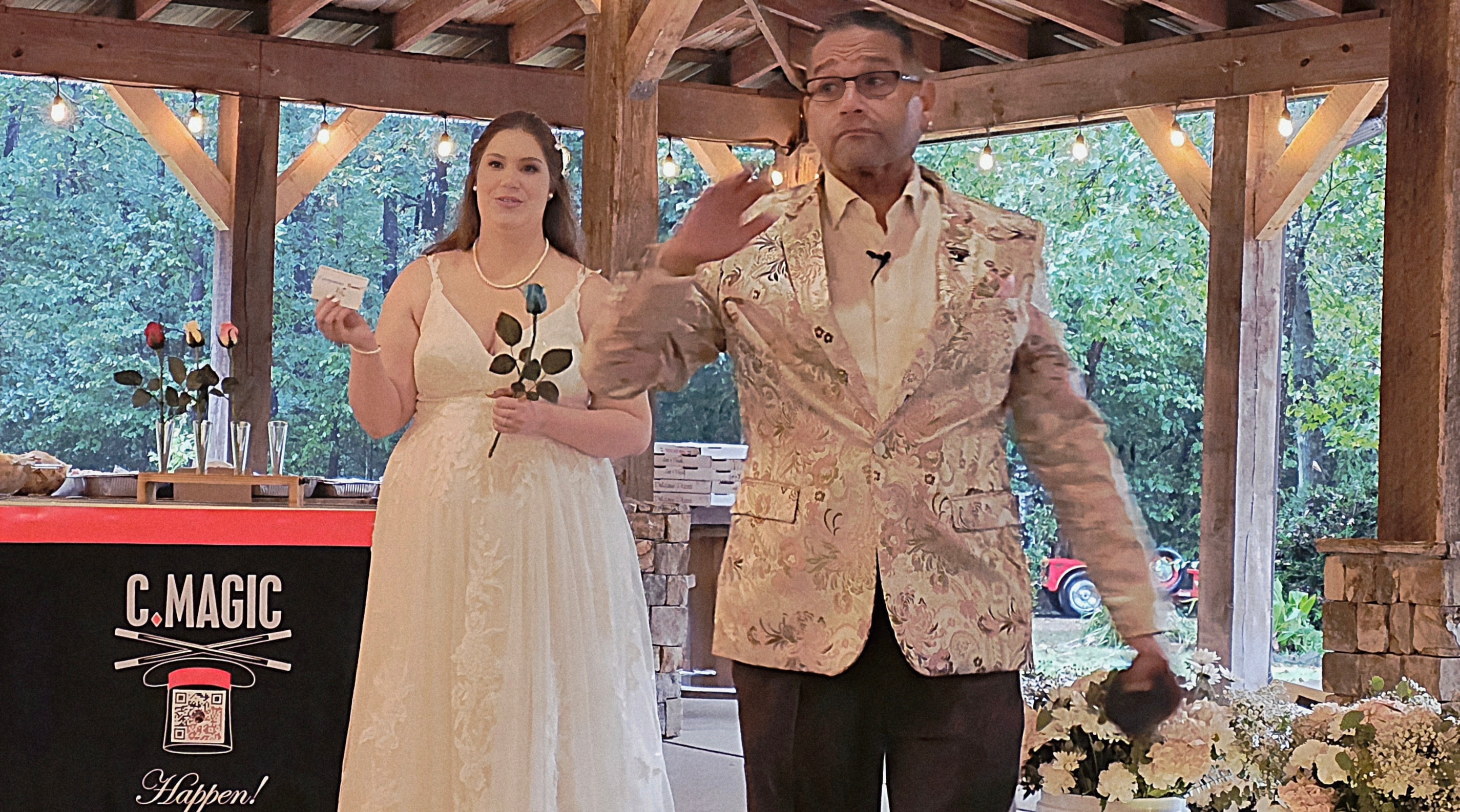 C. Magic performing close-up magic with bride at the C. Magic Happen table
