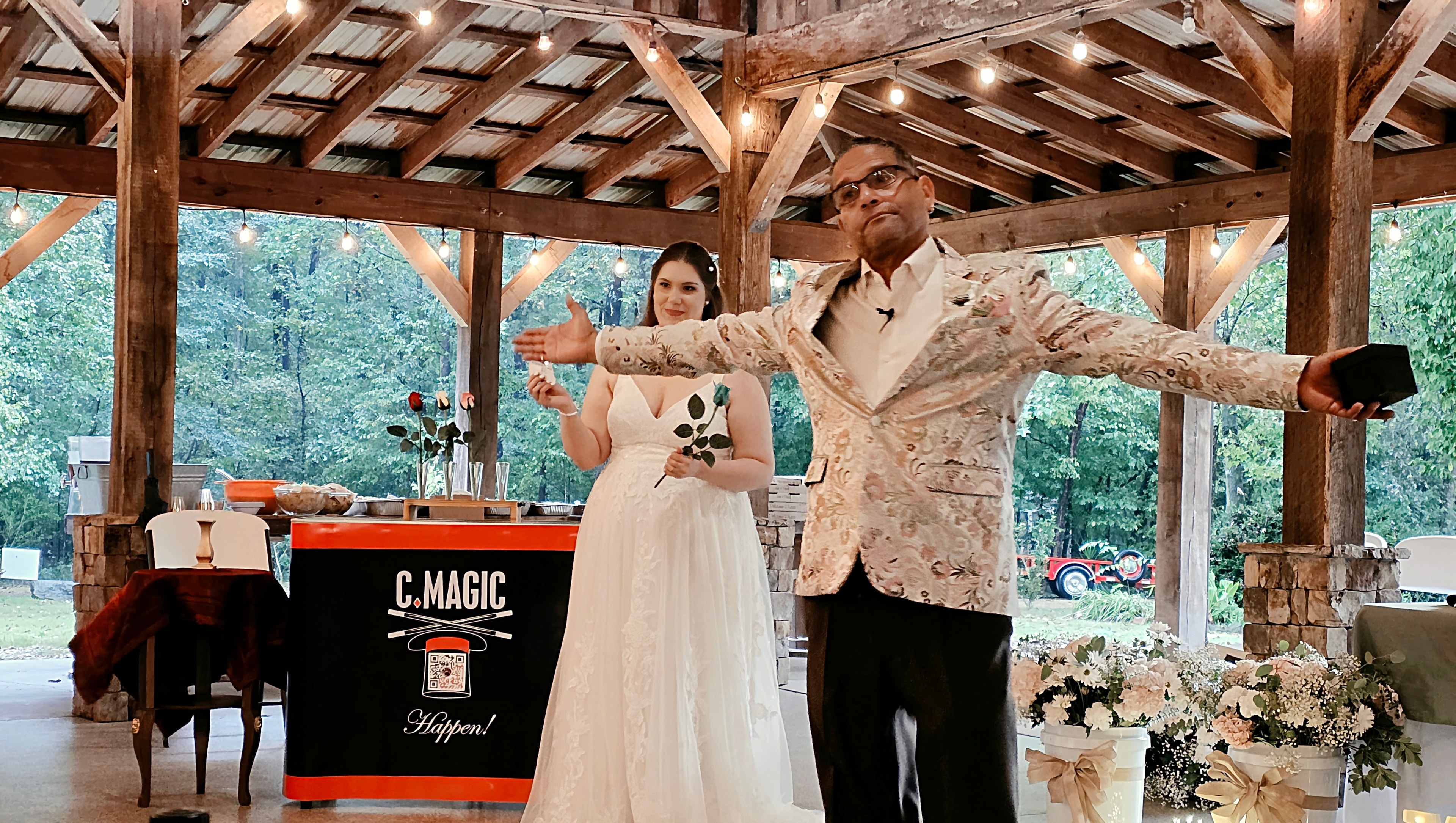 C. Magic and bride performing magic trick together at outdoor pavilion reception