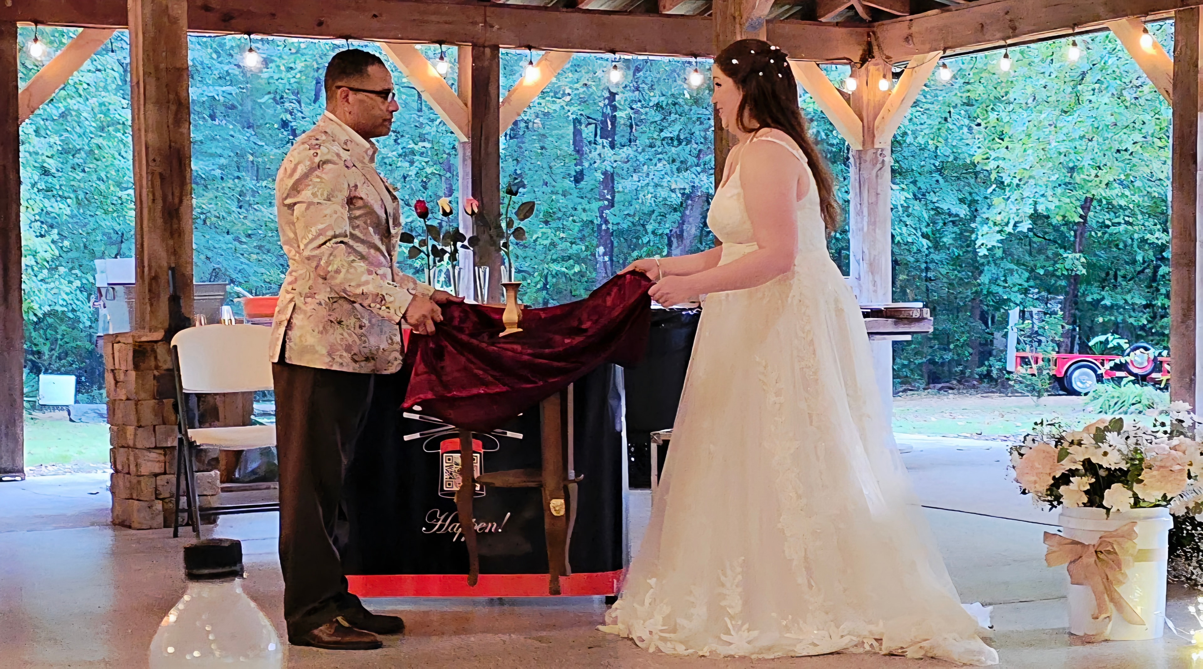 C. Magic and bride performing grand reveal magic trick at outdoor pavilion
