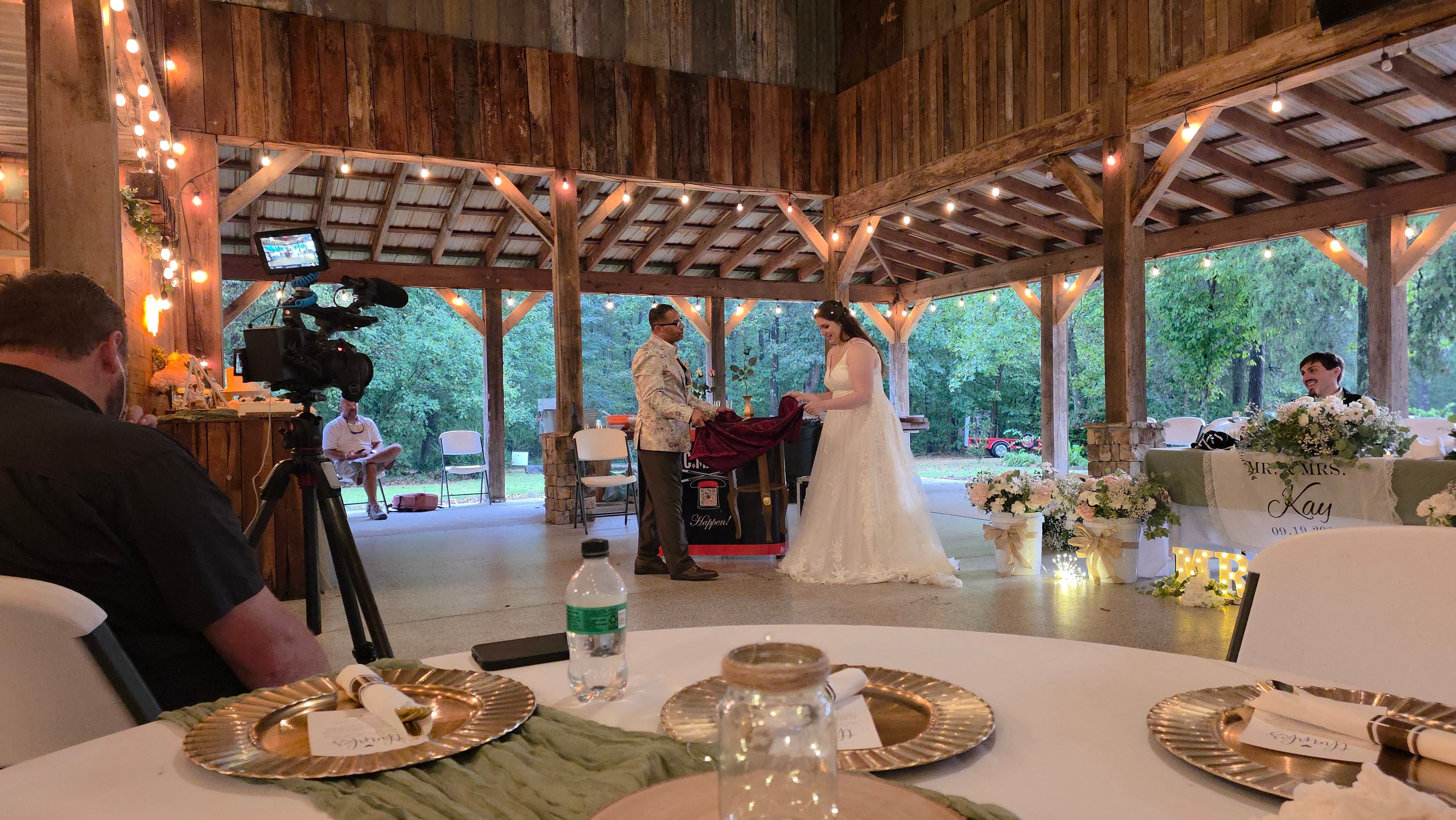 C. Magic and bride performing tablecloth magic trick at wedding reception
