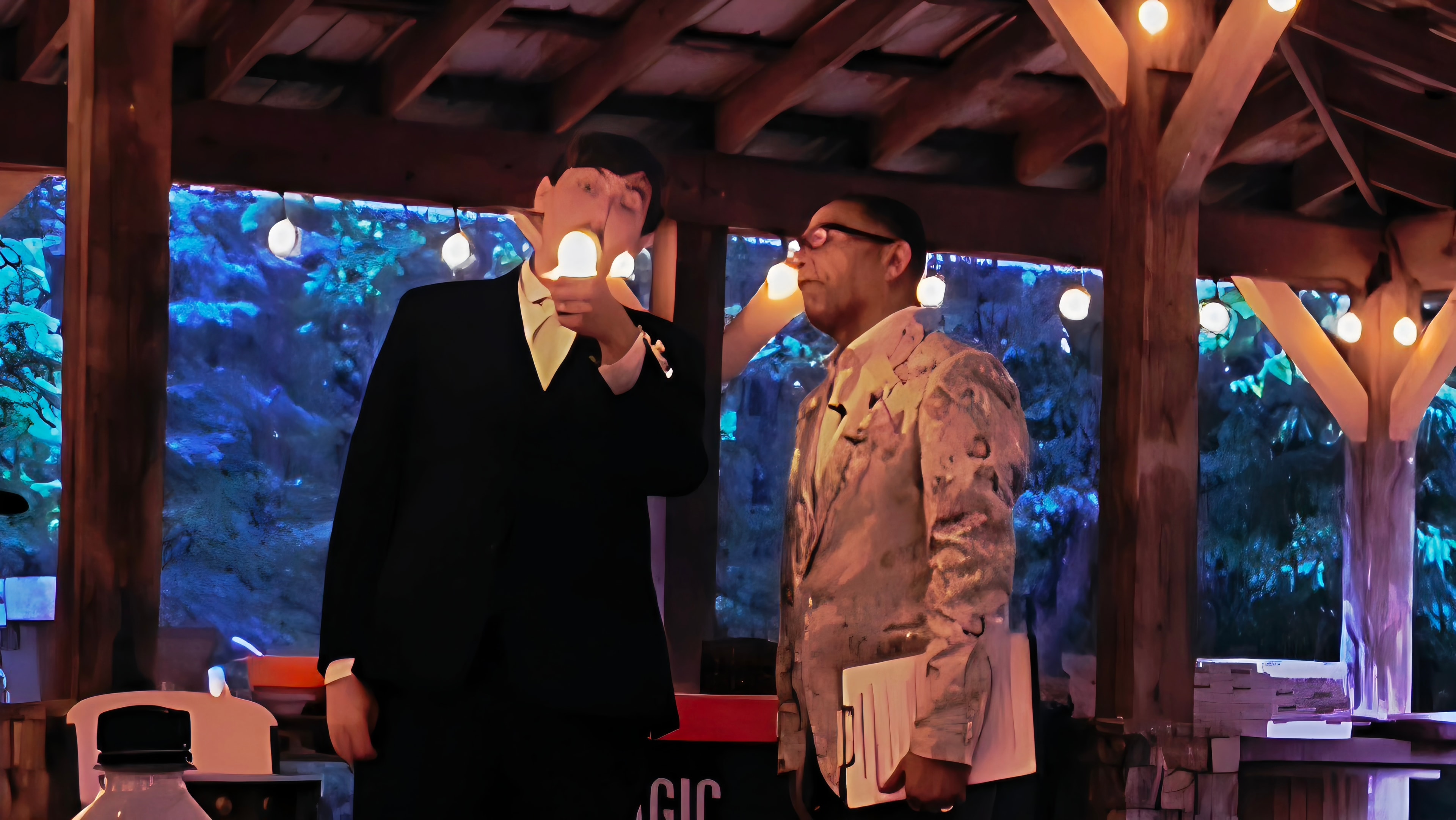 C. Magic and groom performing light bulb trick at the Allen wedding pavilion