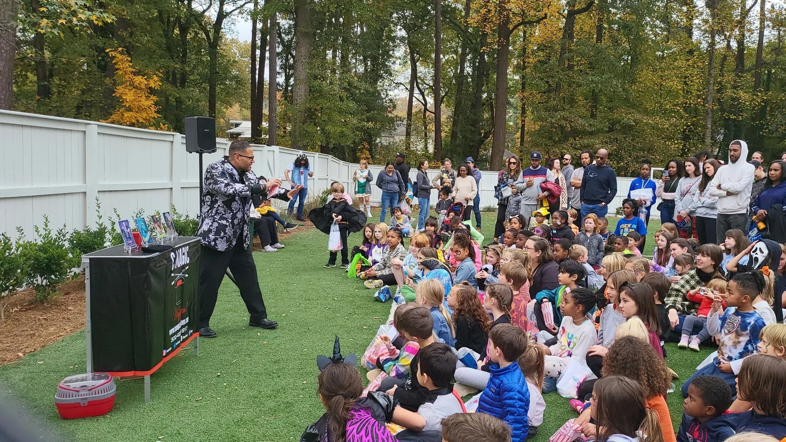 C. Magic reading to children at outdoor gathering